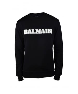 Sudadera Balmain de algodón negro.Logotipo retro de terciopelo blanco en la parte delantera. Cuello redondo.Bajo recto.Bordes de canalé.100% algodón.