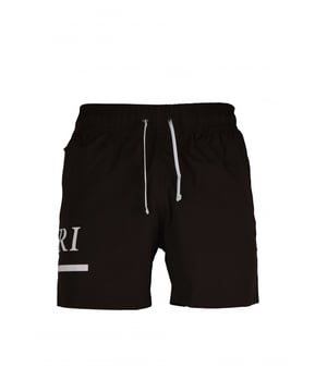 Amiri bruine zwemshort van polyester en elastaan.Wit Amiri en MA-logo gedrukt op de zijkant van één been.Elastische taille met trekkoord.Zijzakken.Eén achterzak met krassluiting.Zwarte logopatch op de achterkant.
