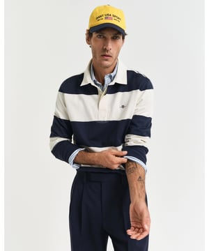 Crafted from 100% cotton, this rugger sports an all-over barstripe design. It is garment-washed for a soft handfeel and cut for a regular fit. This rugger features all the classic detailing: a twill collar, ribbed cuffs, a stitched placket with branded rubber buttons and side hem slits. It is finished with a GANT shield graphic embroidered at the chest and our signature locker loop at the back. 

Regular fit
Twill collar
Barstripe design
Ribbed cuffs

100% Cotton
2067017