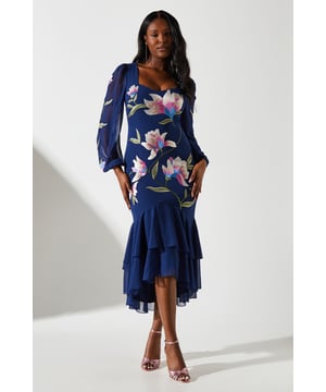 Exquisite embroidered floral design
        Elegant square neckline
        Long sleeves with ruffle detailing
        Fitted silhouette with flounced hem
        Tie-back feature for adjustable fit
    
    Make a striking entrance at your next soire with this captivating long sleeve dress from Coast. The intricate embroidered floral pattern adds a touch of artisanal charm, while the square neckline frames your dcolletage beautifully. The fitted silhouette gracefully hugs your curves before cascading into a flounced hem, creating a mesmerising silhouette as you move. Perfect for a night out on the town, this dress pairs wonderfully with strappy heels and statement earrings. For a more refined look, opt for a sleek updo and a clutch bag. Whether you're heading to a cocktail party or a special dinner, this dress is sure to turn heads and keep you feeling confident all night long.