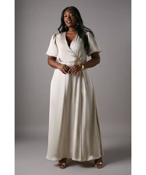 Elegant wrap neckline with flattering puff sleeves for a sophisticated silhouette
        Flowing A-line skirt design that gracefully skims the figure
        Luxurious satin fabric that catches the light beautifully
        Delicate tie detail at the back adding a refined finishing touch
        Full-length design measuring 155cm from shoulder to hem for a dramatic bridal party presence
    
    This stunning Coast bridesmaids dress combines timeless elegance with contemporary details. The graceful wrap neckline frames the dcolletage beautifully, while the statement puff sleeves add a touch of romance to your bridal party ensemble. The A-line silhouette creates a flattering shape that complements all figures, flowing effortlessly from the defined waistline to the floor-sweeping hem. Style with delicate metallic accessories as shown on our model - statement earrings and a simple bracelet provide just the right amount of sparkle without overwhelming the dress. Complete your bridesmaids look with elegant updos to showcase the neckline and sleeves, and pair with neutral toned heels for a cohesive wedding party aesthetic that photographs beautifully alongside the bride.