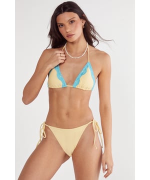 Stylish three-piece set featuring a triangle bikini top with decorative lace trim detailing
        Side-tie bikini bottoms with adjustable strings for a customised fit
        Coordinating mini skirt with matching lace trim and side slits for effortless beach-to-bar transitions
        Halterneck design with tie fastening for secure and adjustable support
        Lightweight, quick-drying fabric perfect for beach days and poolside lounging
    
    Make a statement on your next sunshine getaway with this eye-catching three-piece bikini set from Nasty Gal. The triangle top features delicate lace trim that adds a feminine touch to the classic silhouette, while the tie-side bottoms allow for the perfect fit. The matching mini skirt serves as a chic cover-up that takes you seamlessly from sunbathing to beachside cocktails. Style with a pearl necklace as shown for an on-trend beach look, or pair with oversized sunglasses and metallic sandals for poolside glamour. This versatile set works brilliantly for everything from lazy days by the pool to sunset beach walks, and packs easily for your summer holiday wardrobe. The contrasting lace detail creates visual interest that will have heads turning wherever your travels take you.