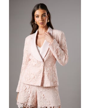 Exquisite lace fabric with intricate floral pattern
        Double-breasted design with elegant satin lapel
        Tailored fit accentuating the feminine silhouette
        Long sleeves for a sophisticated look
        Versatile piece suitable for various formal occasions
    
    This stunning lace blazer from Coast is the epitome of refined elegance. The double-breasted design, adorned with a luxurious satin lapel, creates a striking contrast against the delicate lace fabric. Perfect for those seeking to make a statement at weddings, races, or any formal event, this blazer radiates sophistication and grace. Style it with the matching lace shorts for a coordinated ensemble, or pair it with tailored trousers for a more classic look. Add a clutch bag and strappy heels to complete your outfit. The versatility of this piece allows for effortless transition from day to evening wear, ensuring you'll stand out with poise at any occasion. Whether you're attending a garden party or a cocktail reception, this Coast blazer will have you looking impeccably polished and feeling confident.