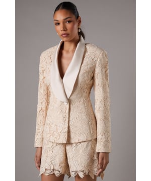 Exquisite lace fabric with intricate floral pattern
        Double-breasted design with elegant satin lapel
        Tailored fit accentuating the feminine silhouette
        Long sleeves for a sophisticated look
        Versatile piece suitable for various formal occasions
    
    This stunning lace blazer from Coast is the epitome of refined elegance. The double-breasted design, adorned with a luxurious satin lapel, creates a striking contrast against the delicate lace fabric. Perfect for those seeking to make a statement at weddings, races, or any formal event, this blazer radiates sophistication and grace. Style it with the matching lace shorts for a coordinated ensemble, or pair it with tailored trousers for a more classic look. Add a clutch bag and strappy heels to complete your outfit. The versatility of this piece allows for effortless transition from day to evening wear, ensuring you'll stand out with poise at any occasion. Whether you're attending a garden party or a cocktail reception, this Coast blazer will have you looking impeccably polished and feeling confident.