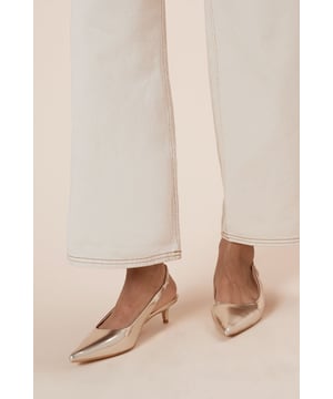 Sleek slingback design for a secure fit
        Pointed toe silhouette adds a touch of sophistication
        Kitten heel measures between 2.5 and 4.5cm for comfortable wear
        Faux leather construction offers a polished look
        Versatile court shoe style suitable for various occasions
    
    Step out in style with the Faelina Faux Leather Slingback Kitten Heel Court Shoes from Dorothy Perkins. These chic shoes strike the perfect balance between comfort and elegance, making them ideal for the fashion-conscious woman in her 30s. The low kitten heel provides just enough lift without sacrificing comfort, perfect for those busy days when you're meeting friends for brunch or attending a baby shower. The pointed toe and slingback design add a touch of sophistication to any outfit, whether you're pairing them with tailored trousers for a smart casual look or a flowing midi dress for a more relaxed ensemble. The versatile nature of these shoes means they can easily transition from day to night, offering endless styling possibilities for the modern woman who values both style and practicality.