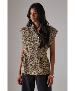 Sleeveless denim jacket with bold leopard print
        Funnel neck for a contemporary edge
        Boxy fit offering a modern silhouette
        Belted waist for a flattering, adjustable fit
        Button-through front for versatile styling options
    
    Make a statement with this eye-catching leopard print sleeveless denim jacket from Warehouse. The boxy fit and funnel neck create a contemporary silhouette that's perfect for the confident, fashion-forward woman. The belted waist allows for a customised fit, accentuating your figure while maintaining a relaxed feel. Ideal for casual events and family gatherings, this versatile piece can be styled in numerous ways. Layer it over a simple black tee and wide-leg trousers for a chic daytime look, or button it up and wear as a standalone top with your favourite jeans for an edgy evening ensemble. The sleeveless design makes it a great transitional piece, easily paired with long-sleeved tops for cooler days. Finish the look with gold hoop earrings and ankle boots to channel effortless urban style.