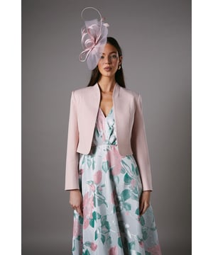 Elegant cropped jacket with sophisticated long sleeves and clean-lined silhouette
        Striking bow detail at the back adds a feminine flourish
        Collarless design with open front creates a sleek, contemporary profile
        Crafted from crepe fabric with slight stretch for comfortable movement
        Fully lined for smooth wear and structured appearance
    
    This beautifully tailored Coast jacket presents the perfect finishing touch for special occasions. The cropped silhouette sits elegantly at the waist, complementing dresses and separates alike, whilst the charming bow detail at the back offers an unexpected twist to a classic design. As shown, pair with a floral midi dress and fascinator for race day sophistication, or style with tailored trousers and a silk camisole for evening events. The clean lines and refined structure make this jacket a versatile investment piece that works brilliantly for weddings, formal gatherings and celebrations. The slight stretch in the fabric ensures comfort throughout the day, whilst maintaining that polished silhouette that Coast is renowned for. Accessorise with delicate jewellery to complete your occasion ensemble with understated elegance.