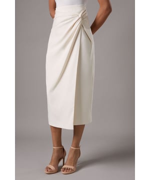 Elegant knot front design for a sophisticated silhouette
        Wrap style skirt with asymmetrical hemline
        Midi length for versatile styling options
        Sleek crepe fabric for a polished look
        Side slit detail adds a touch of allure
    
    Make a statement at your next formal event with this exquisite knot front wrap skirt from Coast. The elegant design features a sophisticated knot detail that creates a flattering drape, while the wrap style and asymmetrical hemline add a contemporary twist to a classic silhouette. Perfect for weddings, races, or any upscale occasion, this midi-length skirt offers endless styling possibilities. Pair it with a tailored blazer and strappy heels for a refined ensemble that commands attention. The sleek crepe fabric ensures a polished look that moves gracefully as you walk, while the side slit adds a subtle touch of allure. Whether you're attending a garden party or a black-tie gala, this versatile skirt will have you looking effortlessly chic and feeling confident throughout the day.