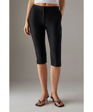 Tailored capri trousers with a sleek mid-calf length
        Clean waistband design for a smooth silhouette
        Practical side pockets for everyday essentials
        Versatile woven fabric with a refined finish
        Streamlined fit that flatters the feminine form
    
    These Warehouse capri trousers offer the perfect balance of comfort and style for the confident modern woman. The tailored fit creates a flattering silhouette that works beautifully for various casual occasions. Style them as shown with a relaxed oversized shirt or crisp white top for an effortlessly chic look. The versatile design makes these trousers ideal for family gatherings, weekend brunches, or casual office days. Pair with minimalist sandals for warmer days or ballet flats for a touch of elegance. The clean lines and thoughtful proportions reflect Warehouse's signature edgy yet feminine aesthetic, making these capris a wardrobe essential that transitions seamlessly from day to evening. Perfect for city breaks or garden parties, these trousers offer both practicality and understated sophistication.