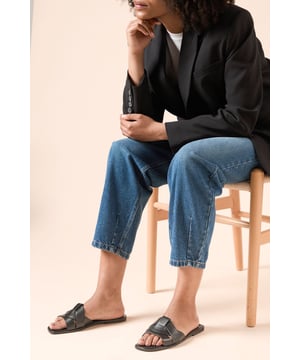 Faux leather sliders with distinctive twisted knot detail for a sophisticated touch
        Flat heel design (under 2cm) ensures all-day comfort without compromising on style
        Open-toe silhouette perfect for showcasing pedicures during warmer months
        Slip-on design for effortless wear and convenience
        Versatile neutral tone that complements a wide range of outfits in your wardrobe
    
    The Felicity Faux Leather Sliders from Dorothy Perkins offer the perfect blend of comfort and contemporary style for the fashion-conscious woman. The elegant twisted knot detail adds interest to these otherwise minimalist sandals, making them a standout accessory for your casual wardrobe. As seen on our model, these sliders pair beautifully with wide-leg trousers and a tailored jacket for a refined daytime look. The flat design ensures you can navigate busy days with ease, whether you're meeting friends for brunch, attending a family gathering, or running weekend errands. Their versatility makes them an essential addition to your summer collection - wear them with flowing maxi dresses, cropped jeans or linen trousers for an effortlessly chic appearance. These sliders will quickly become your go-to footwear choice for those occasions when you want to look polished without sacrificing comfort.