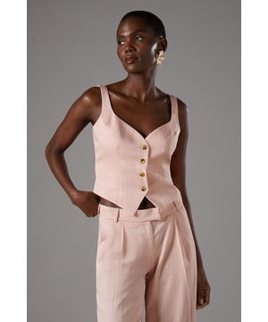 Elegant pinstripe crepe waistcoat with flattering V-neckline
        Strappy design with wide shoulder straps for comfortable wear
        Decorative gold-tone button fastening down the front
        Tailored fit with a slightly cropped silhouette
        Versatile separate that can be styled as part of a coordinating set
    
    This sophisticated Coast waistcoat offers a contemporary twist on traditional tailoring. The strappy design and V-neckline create a feminine silhouette whilst maintaining a structured, polished appearance. Style as seen with the matching wide-leg trousers for a refined coordinating ensemble perfect for summer occasions. For race day elegance, pair with a fascinator and statement earrings, or dress down for garden parties with delicate sandals and a clutch bag. The versatile piece transitions beautifully from day to evening events-simply add a tailored blazer for cooler evenings. The structured crepe fabric holds its shape beautifully whilst offering comfort throughout your special occasion. A timeless investment piece that will become a cornerstone of your occasion wardrobe for seasons to come.