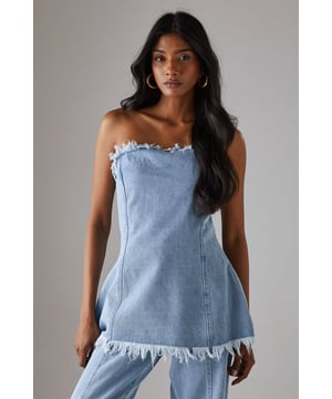 Strapless bandeau design with distinctive frayed edge detailing along the top and bottom hems
        Structured cotton denim fabric provides excellent shape retention and support
        Flattering A-line silhouette that gently flares from the bust to create a feminine profile
        Versatile length that works perfectly as a standalone top or layered piece
        Visible seam detailing adds architectural interest and enhances the contemporary aesthetic
    
    This Warehouse denim bandeau top brings effortless edge to your daywear collection. The raw, frayed edges create a deliberately undone finish that contrasts beautifully with the structured silhouette. Style with the matching frayed denim trousers for a coordinated set that makes a statement, or break it up with your favourite high-waisted jeans for a double denim moment. For casual outings, pair with trainers and oversized gold hoops for an ensemble that transitions seamlessly from weekend brunches to afternoon shopping trips. The cotton fabric offers breathable comfort whilst maintaining its shape throughout the day. This piece embodies Warehouse's confident, feminine aesthetic - perfect for the fashion-forward woman who appreciates contemporary design with a touch of attitude.