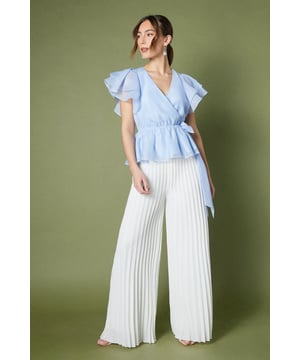 Ethereal organza fabric for a luxurious look and feel
        Flattering wrap design with a cinched waist
        Romantic frill detailing on the sleeves
        Elegant V-neckline to enhance your dcolletage
        Versatile peplum silhouette for a feminine touch
    
    Embrace sophistication with this enchanting organza frill wrap top from Coast. Perfect for those special occasions that demand a touch of elegance, this top radiates refinement and grace. The wrap design cinches at the waist, creating a flattering silhouette that complements your figure, while the frilled sleeves add a whimsical and romantic flair. Style this versatile piece with tailored wide-leg trousers and strappy heels for a chic ensemble at a summer wedding or pair it with a sleek pencil skirt for a polished look at the races. For a more relaxed yet equally stylish outfit, team it with high-waisted jeans and statement earrings for an elevated brunch date. The organza fabric lends an air of luxury to any ensemble, ensuring you stand out at your next formal event or special celebration.