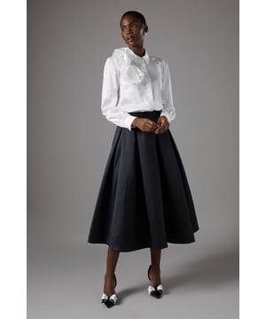 Voluminous A-line silhouette for a dramatic flair
        High-waisted design accentuates the natural waistline
        Pleated detailing adds texture and movement
        Midi length offers versatile styling options
        Smooth twill fabric provides structure and elegance
    
    Make a striking entrance at your next formal event with this captivating full volume skirt from Coast. The generous A-line silhouette creates a sweeping, dramatic effect that's sure to turn heads. Crafted from smooth twill fabric, this skirt offers both structure and fluidity, allowing for graceful movement as you walk. The high-waisted design elongates your silhouette, while the pleated detailing adds a touch of sophistication. Perfect for weddings, race days, or elegant soires, this skirt can be styled in numerous ways. Pair it with a crisp white blouse and pointed-toe heels for a classic look, or opt for a sleek bodysuit and statement jewellery for a more contemporary ensemble. The versatile midi length ensures this skirt will become a staple in your occasion wear wardrobe, ready to be customised for various events throughout the season.