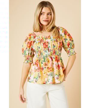 Charming floral print peplum top
        Ruched bodice for a flattering fit
        Romantic puff sleeves with elasticated cuffs
        Sweetheart neckline adds a feminine touch
        Versatile woven cotton fabric for comfort
    
    Embrace the beauty of nature with this enchanting floral peplum top from Dorothy Perkins. Perfect for the fashion-conscious woman in her 30s, this top strikes the ideal balance between trendy and modest. The ruched bodice creates a figure-flattering silhouette, while the puff sleeves add a touch of whimsy. Pair it with white wide-leg trousers and sandals for a chic brunch ensemble, or dress it up with a midi skirt and ballet flats for a baby shower. The versatile design makes it suitable for various casual events and family gatherings. The sweetheart neckline offers a subtle hint of allure without revealing too much, making it an excellent choice for those who prefer a more reserved style. This top is a delightful addition to any wardrobe, offering both comfort and style for the modern woman.