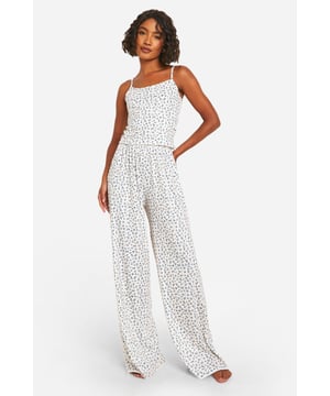 Stylish pyjama set with all-over print
        Comfortable jersey fabric for a soft feel
        Adjustable spaghetti straps for a perfect fit
        Wide-leg trousers for unrestricted movement
        Designed for taller frames with extended length
    
    Drift off to dreamland in style with this chic pyjama set, perfect for the fashion-forward sleeper. The all-over print adds a touch of whimsy to your nighttime routine, while the jersey fabric ensures maximum comfort throughout the night. The adjustable spaghetti straps allow for a customised fit, catering to your individual needs. The wide-leg trousers offer ample room for movement, ideal for those who prefer a less restrictive sleeping experience. This set is specifically designed with taller frames in mind, featuring extended lengths to ensure a proper fit. Whether you're having a leisurely breakfast in bed or settling in for a cosy night of Netflix, this versatile pyjama set is your go-to choice for both comfort and style. Pair with fluffy slippers and a soft dressing gown for the ultimate loungewear look.