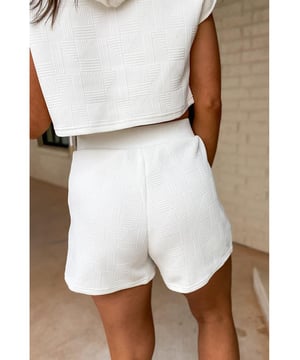 Our styles are designed with a trendy fitted look in mind following an international size standard. For the best fit we suggest choosing one size up from your usual. Be sure to check our sizing chart to find your perfect match!
  White textured cropped hoodie and shorts set
  Drawstring hoodie with a loose cropped fit
  Matching pair of comfortable shorts
  Casual style suitable for daily occasions
  Medium
  high elasticity for a comfortable fit
Material: 95% Polyester 5% Elastane