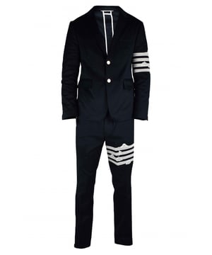 Traje de dos piezas Thom Browne azul marino.Broderie anglaise blanco en la manga izquierda con 4 rayas.Cierre delantero de 2 botones y puños abotonados. 2 bolsillos delanteros con solapa y un bolsillo en el pecho.Pantalón con cierre de cremallera y botón.Bordado similar en la pierna izquierda.