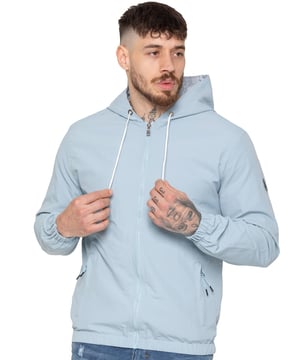 The Enzo Milano Men's Windbreaker Jacket offers a sleek, lightweight design with a regular fit. Made from durable tech fabric, it features a full zip, adjustable drawstring hood, and elasticated cuffs for added comfort and protection. With two concealed zip pockets, a single inner pocket, and an elasticated hem with a drawcord toggle, this water-Repellent jacket is perfect for everyday wear in light rain or windy conditions. Finished with the signature Enzo Milano rubber badge for a stylish touch.