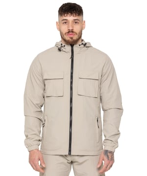 The Enzo Milano Men’s Lightweight Cargo Jacket is a sleek, functional outer layer made from water-repellent crushed poly fabric with a breathable mesh lining for all-day comfort. Designed in a regular fit, it features a full zip front, high neck, and adjustable drawcord hood for versatile coverage. With two Velcro chest pockets, two zippered side pockets, elasticated cuffs, and an adjustable drawcord hem, it offers both style and practicality—perfect for layering in changing weather.