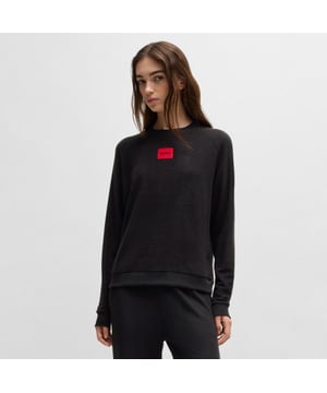 Dames HUGO Snoozie Relaxed-fit Sweatshirt in badstof met rood logolabel in zwart.Een signature sweatshirt in een relaxte pasvorm van HUGO. Afgezet met een logopatch in HUGO-rood is deze top gemaakt van zachte badstof.  - Ronde hals- Relaxte pasvorm- Hoofdmateriaal: 64% Modal 33% Polyacryl 3% Elastaan.  Machinewasbaar - Ref: 50523414-001