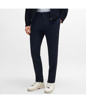 Heren BOSS L-Gee Slim Fit Broek in donkerblauw.Formele broek met een drawcord taille van BOSS Menswear. De broek combineert luxe met prestaties en is gemaakt van stretchstof met een gestroomlijnde pasvorm. - Slim fit- Hoofdmateriaal: 98% scheerwol 2% elastaan.  Zakken: 100% Katoen.  Knievoering: 100% viscose.  Stomerij - Ref: 50520321-404