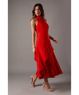 Striking high neck design with an eye-catching corsage detail
        Elegant midi length for a sophisticated silhouette
        Flattering fitted bodice with a flared skirt
        Sleeveless style perfect for warm-weather occasions
        Stunning back detail with a graceful tie fastening
    
    Make a lasting impression at your next formal event with this captivating high neck midi dress from Coast. The show-stopping corsage detail at the neckline adds a touch of drama and femininity, while the fitted bodice and flared skirt create a flattering, hourglass silhouette. The midi length is ideal for a variety of occasions, from weddings to race days. Style this versatile piece with strappy heels and a clutch bag for a polished look. For cooler evenings, drape a lightweight shawl over your shoulders. The back tie fastening adds an extra element of allure, ensuring you'll turn heads from every angle. This dress is a true embodiment of Coast's commitment to sophisticated, occasion-ready fashion that doesn't compromise on style or quality.