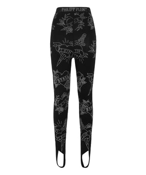 Descubra el placer de ser sexy con estos leggings de punto de rayón elástico enjoyados.    Punto elástico de mezcla de rayón   Aplicaciones de strass Love Tattoo   Marca de strass en la cintura elástica   Puños de estribo   Costura a dos agujas