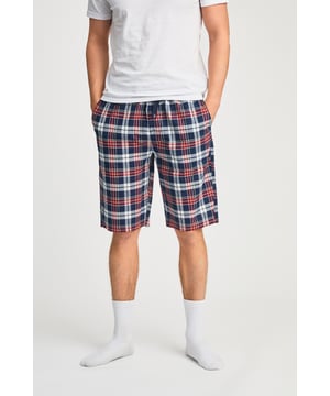 These Tokyo Laundry boxer-style checked lounge shorts are made from 100% cotton with a garment-washed finish for ultimate comfort. Designed with an elastic waistband and adjustable drawstring, they offer a relaxed fit, making them perfect for everyday lounging. Stylish, breathable, and effortlessly casual.