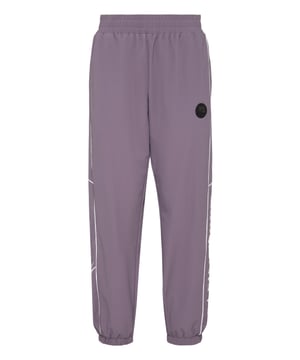 These joggers are the perfect match to achieve your goals. Comfort and performance add up to the style of Plein Sport.   Stretch nylon   Elasticated waistband   Contrasting colored piping    Prints   Rubberized Patch sewn on the left leg   Two slit pockets   Elasticated bottom cuffs