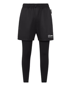 These 2-in-1 training pants are designed for jogging and achieve your goals in the best condition. Comfort and performance add up to the style of Plein Sport.   Matte nylon shorts and stretch cotton jersey leggings   Elasticated waistband with drawstring   Two slit pockets   Rubberized patch with Logo sewn on left leg