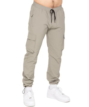 Stay ready for anything with the Enzo Milano Men’s Cargo Pants. Made from lightweight, poly fabric, these straight-leg trousers feature a regular fit, elasticated waistband with adjustable drawstring, and drawstring hems for a custom fit. With two Velcro-fastened side cargo pockets and a back welt pocket, they offer secure, practical storage. Perfect for everyday wear, travel, or outdoor use, these men’s cargo pants combine comfort, function, and style.