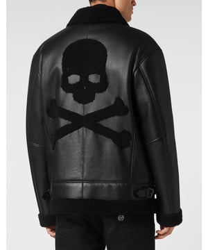 Discover the style of Plein with this sheepskin jacket. Check out its distinctive details.   Sheepskin with fur trim finish   Shearling shirt collar with two leather straps   Shearling Skull&Bones on the back   PP Hexagon on a saffian leather patch sewn at left chest   Zip fastener   Two slit pockets with stitched outline   Two side straps on bottom hem   Unlined
