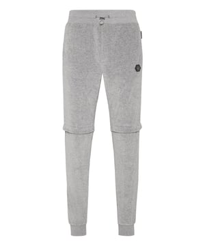 Choose to jog in style with the uniqueness identifying the style of Plein. We designed these soft chenille pants. Check out all its details.   Chenille velvet   Legs with stud buttons fastening   Stitching details   PP Hexagon on a saffian leather badge sewn on the left side   Slit pockets   Ribbed waistband with stop-cord drawstring   Rib knit cuffs