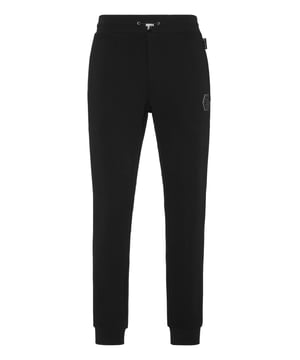 Descubra la originalidad de estos pantalones de chándal de forro polar de mezcla de algodón decorados con detalles únicos.   Forro polar de mezcla de algodón   Letras estampadas   Parche con logotipo   Bolsillos con aberturas   Cintura de canalé con cordón de ajuste de tope   Puños de punto elástico