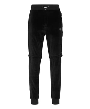 Choose to jog in style with the uniqueness identifying the style of Plein. We designed these soft chenille pants. Check out all its details.   Chenille velvet   Legs with stud buttons fastening   Stitching details   PP Hexagon on a saffian leather badge sewn on the left side   Slit pockets   Ribbed waistband with stop-cord drawstring   Rib knit cuffs