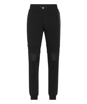 Pantalones de chándal de forro polar de algodón Iconic Plein.   Suave forro polar de mezcla de algodón   Hexágono PP de piel saffiano   Bolsillos con aberturas   Cintura acanalada con cordón de tope   Puños de punto elástico.