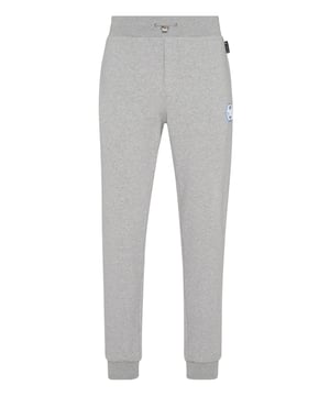 Descubra la originalidad de estos pantalones de chándal de forro polar de mezcla de algodón decorados con detalles únicos.   Forro polar de mezcla de algodón   Letras estampadas   Parche con logotipo   Bolsillos con aberturas   Cintura de canalé con cordón de ajuste de tope   Puños de punto elástico