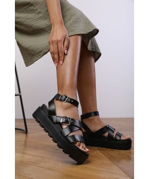Stay stylish and comfortable all day with our Emily Buckle Strap Platform Sandals. These sandals are a perfect addition to your footwear collection, featuring a trendy design that will elevate your outfit.
Key Features:


Effortless Style: The platform design and buckle strap detail of these sandals ensure they stand out with their fashionable and trendy appeal. They effortlessly add a chic and stylish element to any outfit you wear.

All-Day Comfort: Our sandals are created with your comfort in mind. They feature a soft insole that provides maximum comfort, allowing you to wear them all day without any discomfort.

Secure Fit: The buckle strap closure allows you to adjust the sandals to your desired fit, providing a secure and snug feel. This ensures stability while walking and adds an extra touch of style to the sandals.

Durable Construction: Made with high-quality materials, our Layla Buckle Strap Platform Sandals are built to last. The sturdy construction and reliable stitching ensure their durability and make them practical for everyday wear.

On-Trend Design: Featuring a platform sole and buckle strap, these sandals are perfect for those looking to stay on-trend. They showcase a contemporary aesthetic that adds a fashionable edge to your overall look.

Specifications:

Material: Faux Leather
Closure: Buckle strap
Platform height: 2.5 inches

Invest in our Emily Buckle Strap Platform Sandals for a perfect combination of style, comfort, and empowerment. Revel in the joy of effortless fashion and enjoy the comfort they provide with every step. Get yours today and elevate your style game with confidence!