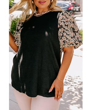 Túnica negra con mangas abullonadas impresas con margaritas  
Paneles negros que favorecen la figura  
La longitud de la túnica alarga la silueta  
Alta elasticidad para un ajuste cómodo  
Combina bien con jeans, leggings, pantalones ajustados, etc.  
Perfecta para todas las temporadas  
Disponible en tallas grandes  
Tabla de tallas disponible a continuación  
Material: 75% Poliéster, 20% Viscosa, 5% Elastano