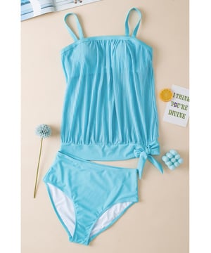 Our styles are designed with a trendy fitted look in mind following an international size standard. For the best fit we suggest choosing one size up from your usual. Be sure to check our sizing chart to find your perfect match!
  Flattering and stylish tankini
  Turquoise striped mesh design
  Trendy knotted hem detail on the top
  High
  rise design for easy pull
  on
  Adjustable straps for a customizable fit
  Removable padded cups for added support and coverage
  Versatile tankini suitable for pairing with coverups
Material: 82% Polyamide 18% Elastane