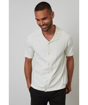 Freshen up your knitwear this season with this stylish knitted shirt from Threadbare. This shirt features textured geometric stitch panels on the front and has a ribbed revere collar and short sleeves, giving a laid-back but refined charm, and has tubular cuffs and hem. Complete with full button-down fastening for easy styling. Pair with chino shorts for an effortless summer aesthetic ormake it date night appropriate with a pair of dark denim jeans and trainers.