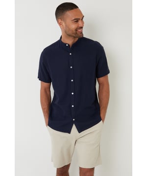 Complete your wardrobe with this short sleeve grandad collar shirt from Threadbare. This shirt features a classic grandad-style collar, making it that little bit different to other shirts you own. Cut in a regular fit and finished with button down fastening. Made from a soft linen blend fabric, this breathable shirt is perfect for the summer months and ideal for layering. Style this shirt with jeans or chinos to complete the look, perfect as a smart evening option.