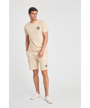 The Tokyo Laundry Logo Beach Set features a printed palm tree design on both the t-shirt and jogger shorts. Ideal for summer holidays, this comfortable, lightweight set is perfect for beach days and warm-weather adventures. A stylish and relaxed choice for your summer wardrobe.