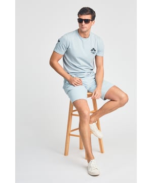 The Tokyo Laundry Logo Beach Set features a printed palm tree design on both the t-shirt and jogger shorts. Ideal for summer holidays, this comfortable, lightweight set is perfect for beach days and warm-weather adventures. A stylish and relaxed choice for your summer wardrobe.