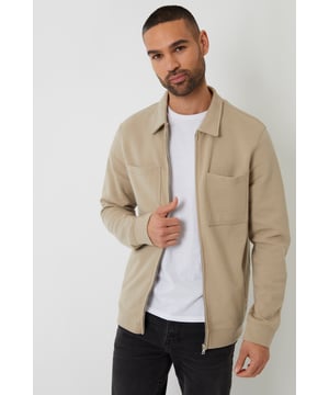 Complete your smart casual wardrobe with pique shacket from Threadbare. Designed with concealed zip through fastening, this lightweight shacket in a jersey pique fabric has long sleeves with self fabric cuffs, a classic collar, two front welt pockets and two handy laid on breast pockets for a practical finish. Team with jeans or chinos for a smart casual outfit that's appropriate for any occasion.