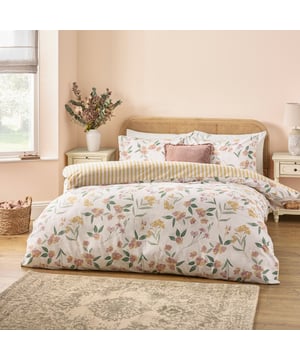 Transform your bedroom into a haven of understated elegance with the Betsie Duvet Cover Set. Designed with a serene nod to the natural world, this reversible set features a delicate floral print on one side and bold stripes on the other, offering versatile styling options. Crafted from a breathable cotton blend, the 180-thread-count reverse ensures a soft, comfortable night's sleep. Perfect for those who value timeless design and superior quality, the Betsie set brings effortless sophistication and a touch of nature-inspired charm to any interior. Create your ideal retreat with this tasteful and refined bedding.