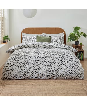 Transform your bedroom into a sanctuary of style and comfort with the Dottie Printed Duvet Cover Set. Crafted from a fabric blend with a 144 thread count, this set offers the perfect balance of softness and durability, ensuring restful nights every time. The playfully dotted design introduces a modern charm to your space, blending style with a hint of personality. Its lightweight, easy-care fabric simplifies your routine, allowing more time to enjoy your refreshed surroundings. Perfect for those who value both practicality and sophistication, this duvet cover set makes any bedroom feel effortlessly chic and uniquely yours.