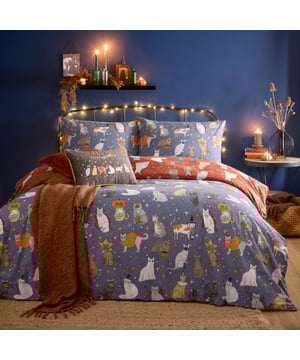 Transform your bedroom into a playful haven of personality with the Halloween Pawty Reversible Duvet Cover Set. This intricately designed set features a charming parade of cats in Halloween costumes, from a mischievous vampire to a cheeky skeleton, all against a backdrop of soft, starry hues. Flip it over for a delightful twist, revealing the cats' backs and capturing their aloof, yet endearing spirit. Crafted for those who love expressing their unique style, this reversible design offers both versatility and a touch of humour, creating a cosy space that’s sure to impress. Add a seasonal, whimsical charm to your home today!