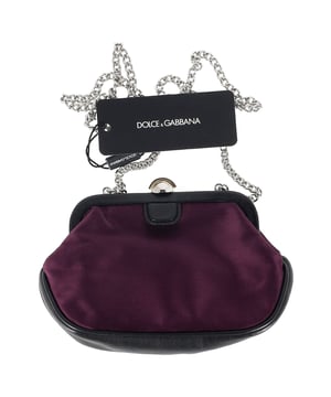 The Dolce & Gabbana Clasp Chain Clutch Bag in dark purple silk combines timeless elegance with bold luxury, featuring a lustrous silk fabric and ornate clasp closure. The rich purple hue adds a regal touch, making it the perfect accessory for evening events or formal occasions. Pair it with a little black dress or a sleek satin gown for a sophisticated, high-fashion look, or contrast it with a more casual outfit to elevate your style. The delicate chain strap allows for versatile wear, whether carried as a clutch or draped elegantly over the shoulder.

 Dolce & Gabbana Clasp Chain Clutch Bag in Dark Purple Silk

Condition: New with tag
Signs of wear: Out of store condition, no visible signs of wear.
Packaging: Dust bag
Color: Purple
Material: Silk
Size: One Size | One Size
Measurements: Width: 50; Height: 120; Length: 200
SKU: NAPPUGBBA464732W